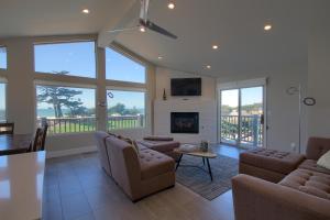 a living room with a couch and a fireplace at Cambria Park Shores in Cambria