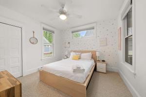 a bedroom with a bed and two windows at The Tamarack - 11 Hollow in Cherry Valley