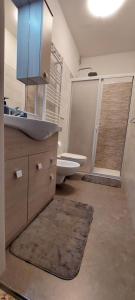 a bathroom with a sink and a toilet and a mirror at Molfetta Central Station Studio in Molfetta