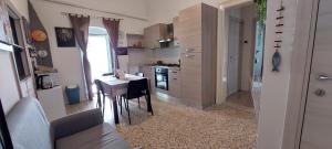 a kitchen with a table and a small table and chairs at Molfetta Central Station Studio in Molfetta