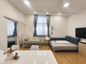 a living room with a couch and a crib at Ruyi holiday -Családi ház in Sopron +83 photos