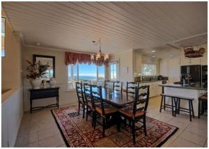 a dining room and kitchen with a table and chairs at Casa Coventry in Cambria +15 photos