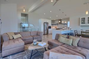 a living room with two couches and a kitchen at Cambria Park Shores in Cambria