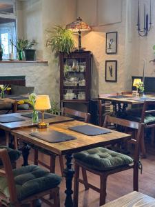 a dining room with wooden tables and chairs at The Bellachroy Hotel in Dervaig
