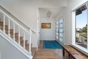 a hallway with stairs and a blue rug at Casa De La Mar in Cambria