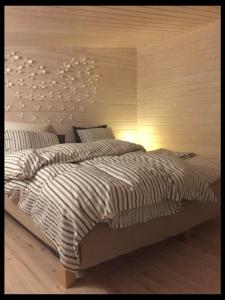 a bedroom with a large bed with a headboard at Nauvo Valmu in Valmoholm