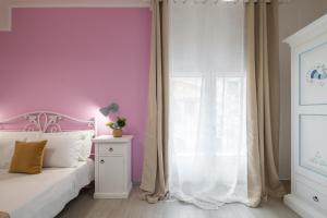 Postel nebo postele na pokoji v ubytování Sa Domu Colorada- Eleganza e comfort nel centro di Villasimius