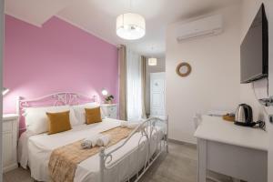 Postel nebo postele na pokoji v ubytování Sa Domu Colorada- Eleganza e comfort nel centro di Villasimius