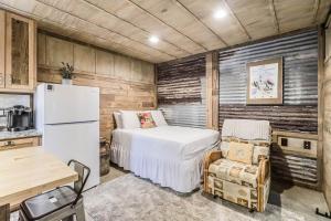 a bedroom with a white bed and a refrigerator at Casas Coastal Experience Cabin C in Rockport