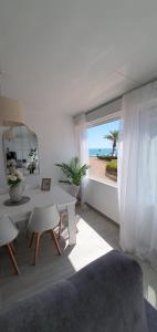 a living room with a table and a view of the ocean at Relax & Sea Apartment - Cabo Cervera - Torrevieja in Torrevieja