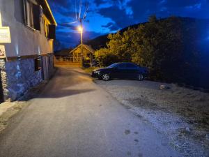 a car parked on the side of a road at night at Konak -Guest house -Ramonda Serbika in Niš