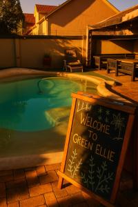 a welcome to green elite sign next to a swimming pool at Green Elephant Backpackers in Cape Town +32 photos