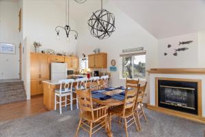 a kitchen with a table and chairs and a fireplace at Casa De Marina in Cambria +27 photos