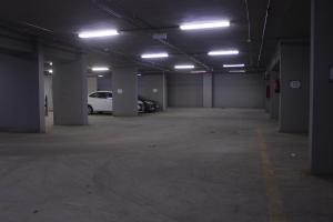 an empty parking garage with a white car parked in it at النسمة الهادئة in Jeddah