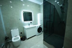 a bathroom with a toilet and a sink and a shower at ЖК Кристалл 160К7 15 этаж 846 in Almaty +10 photos