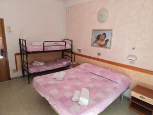 Postel nebo postele na pokoji v ubytování Hotel Rosa