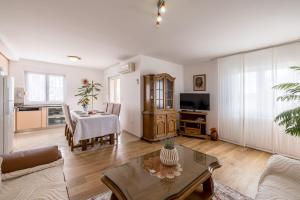 a living room with a table and a dining room at Apartments Nada in Trogir