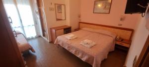 Postel nebo postele na pokoji v ubytování Hotel Rosa