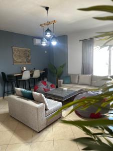 a living room with a couch and a table at Gjonis house in Sarandë