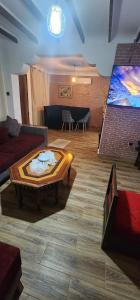 a living room with a couch and a coffee table at Villa dream ainturk in 'Aïn el Turk