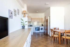 a kitchen with a table and a dining room at Aegean Blue in Ligaria
