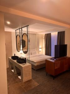 a hotel room with a bed and a television at Hotel Pljevlja in Pljevlja
