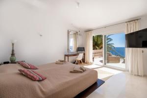 a bedroom with a bed with a view of the ocean at Villa Vista Mar in Santa Ponsa