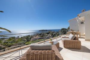 a balcony with wicker furniture and a view of the ocean at Villa Vista Mar in Santa Ponsa