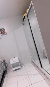 a bathroom with a glass door and a toilet at Apartamento Mobiliado bem localizado na Augusto Montenegro in Belém