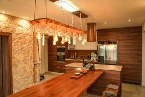 a kitchen with a wooden counter top in a room at Villa Beelvita&Jacuzzi in Bielovce