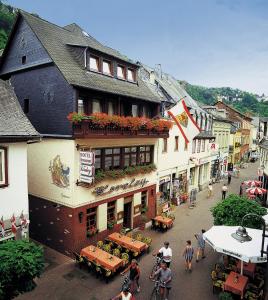 a group of people walking around a street in a town at Hotel zur Loreley in Sankt Goar