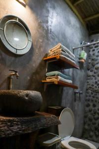a bathroom with a sink and a toilet and a mirror at Cabañas Mannan in Tanchachín +212 photos