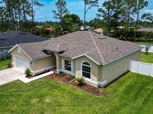 a house with a roof on a yard at Spacious with Private Pool Ideal for Families in Palm Coast