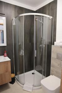 a shower with a glass door in a bathroom at Wrzosowa 34 in Augustów +32 photos