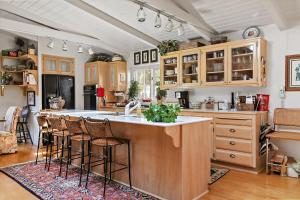 a kitchen with a large island with bar stools at Home Sweet Home New Monthly in Cambria +22 photos
