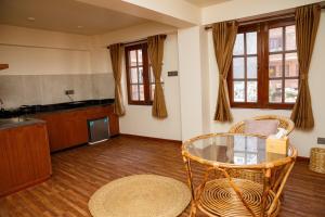 a living room with a glass table and chairs at Mandah Heritage Home in Kathmandu
