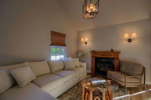 a living room with a white couch and a fireplace at Bridge Street Beauty in Cambria