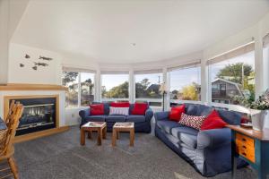 a living room with a couch and a fireplace at Casa De Marina in Cambria
