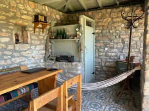 a room with a wooden desk in a stone wall at Altona North in Shabla