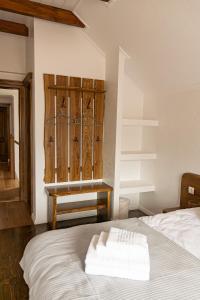 a bedroom with a bed and a wooden door at Cekan Family Guest House in Gura Rîului