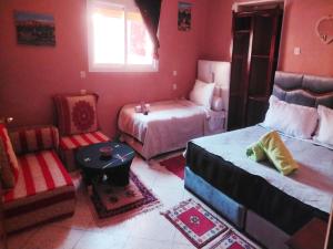 Postel nebo postele na pokoji v ubytování kasbah amlal