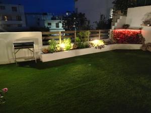 a garden with lights on a balcony at night at Georgia's garden 2 in Sitia