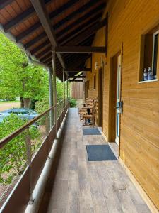 a covered porch of a house with tables and chairs at Ma Campagne in Saint-Rémy
