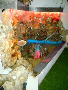a painting of a pond with rocks and water at Georgia's garden 2 in Sitia +1 photo