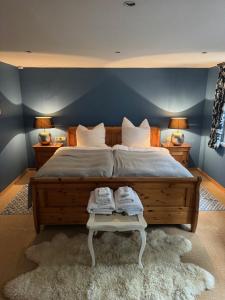 a bedroom with a large bed with two lamps and a rug at Historische Mühle am Schloss in Amöneburg