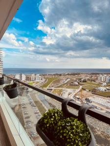 a balcony with a view of a city and the ocean at Grand Sapphire Resort & Casino in Phikardhou