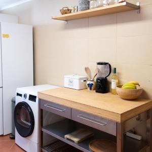 a kitchen with a counter with a washing machine at Casa La Rosa with private pool in Loja de Vendas