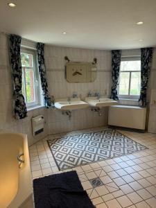 a bathroom with two sinks and a mirror at Historische Mühle am Schloss in Amöneburg +43 photos