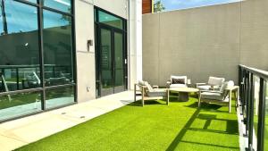 a patio with chairs and a table and grass at 1BR Getaway Pool Gym in Austin