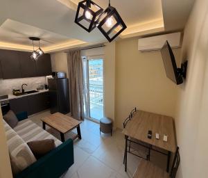 a living room with a couch and a table at GK Luxury Suites in Alexandroupoli
